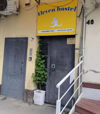 a sign on the side of a building with a door at Oneone eleven hostel in Belgrade