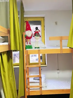 a room with bunk beds with a elf on a ladder at Oneone eleven hostel in Belgrade