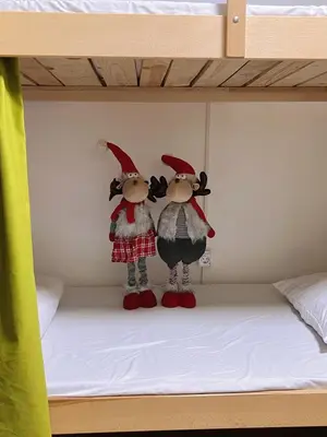 two gnome dolls sitting on top of a bunk bed at Oneone eleven hostel in Belgrade