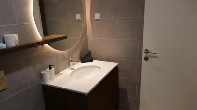 a bathroom with a sink and a mirror at Belgrade Waterfront - Free Parking - Echo in Belgrade