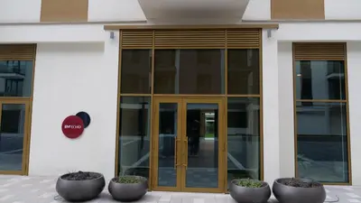 a building with glass doors and flower pots in front of it at Belgrade Waterfront - Free Parking - Echo in Belgrade