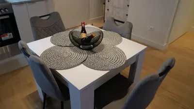 a white table with a bottle of wine on it at Belgrade Waterfront - Free Parking - Echo in Belgrade