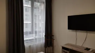 a room with a flat screen tv and a window at Belgrade Waterfront - Free Parking - Echo in Belgrade