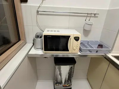 a microwave sitting on a shelf in a kitchen at Urban Studio Vračar Centar - Central Belgrade in Belgrade
