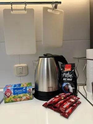 a kitchen counter with a tea pot and some snacks at Urban Studio Vračar Centar - Central Belgrade in Belgrade
