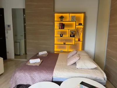 a bedroom with a large bed with two pillows at Urban Studio Vračar Centar - Central Belgrade in Belgrade