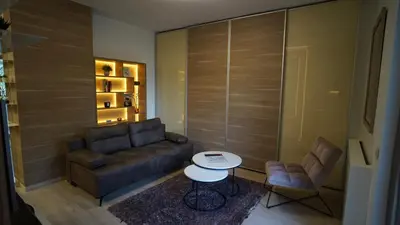 a living room with a couch and a table at Urban Studio Vračar Centar - Central Belgrade in Belgrade