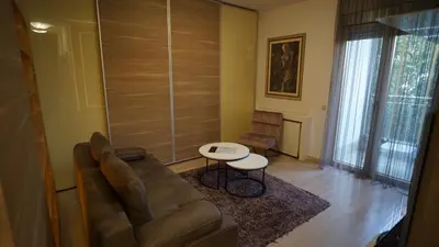a living room with a couch and a table at Urban Studio Vračar Centar - Central Belgrade in Belgrade