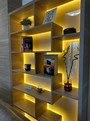 a book shelf with lights in a room at Urban Studio Vračar Centar - Central Belgrade in Belgrade