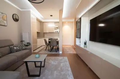 a living room with a couch and a table at Jana BW apartman in Belgrade