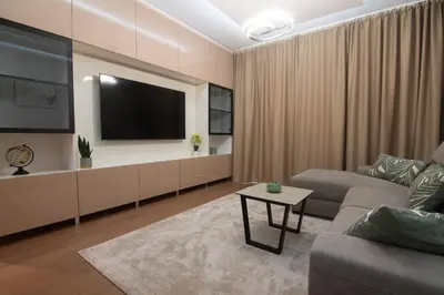 a living room with a couch and a flat screen tv at Jana BW apartman in Belgrade