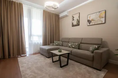a living room with a couch and a table at Jana BW apartman in Belgrade