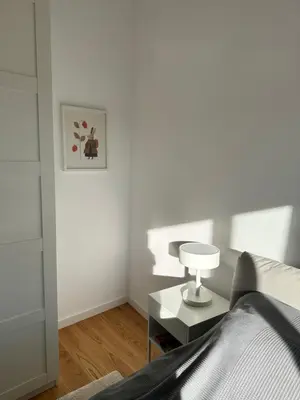 a bedroom with a bed and a table with a lamp at Apartment 6 Belgrade in Belgrade