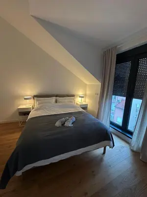 a bedroom with a bed with two stuffed animals on it at Apartment 6 Belgrade in Belgrade