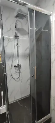 a shower with a glass door in a bathroom at Republic square central in Belgrade