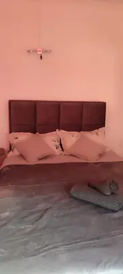 a bedroom with a large bed with pink walls at Republic square central in Belgrade
