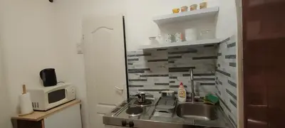 a small kitchen with a sink and a microwave at Republic square central in Belgrade