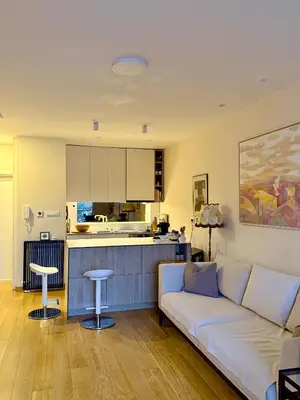 a living room with a couch and a kitchen at Cozy Luxury Studio with City View in Belgrade