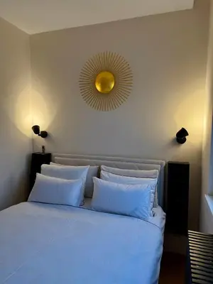 a bedroom with a bed with a mirror on the wall at Cozy Luxury Studio with City View in Belgrade
