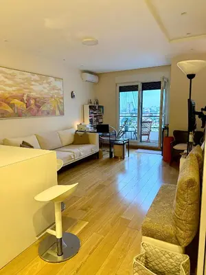 a living room with a couch and a table at Cozy Luxury Studio with City View in Belgrade