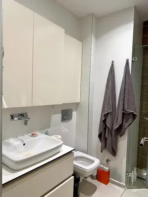 a bathroom with a sink and a toilet at Cozy Luxury Studio with City View in Belgrade