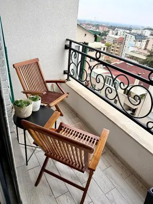 two chairs and a table on a balcony at Cozy Luxury Studio with City View in Belgrade