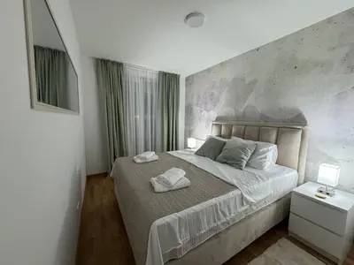 a bedroom with a bed with two towels on it at La Homa LUX in Pančevo