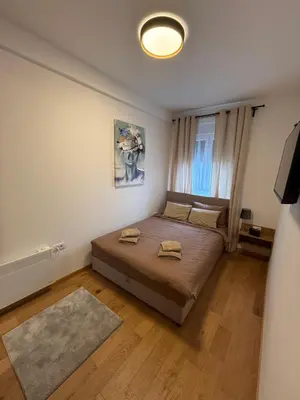 a bedroom with a bed with two towels on it at Fagus apartments in Arandjelovac