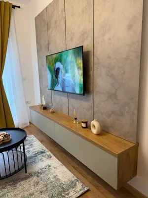 a living room with a tv on a wall at Fagus apartments in Arandjelovac