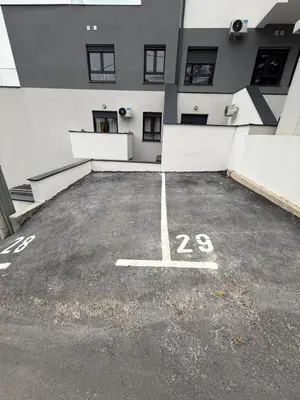a parking lot in front of a building at Fagus apartments in Arandjelovac