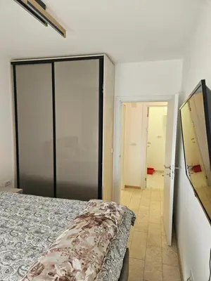 a bedroom with a bed and a sliding glass door at Miss Extra LuX in Mladenovac