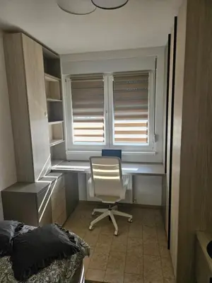 a bedroom with a desk and a chair in front of a window at Miss Extra LuX in Mladenovac