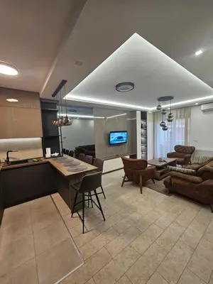 a living room with a couch and a table at Miss Extra LuX in Mladenovac