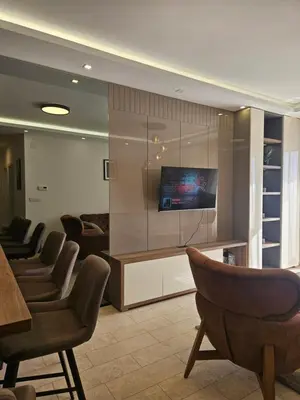 a waiting room with chairs and a flat screen tv at Miss Extra LuX in Mladenovac