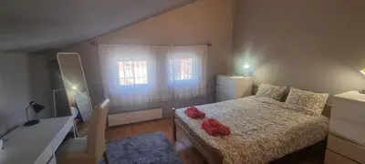 a bedroom with a bed with red towels on it at IVA Apartman in Belgrade