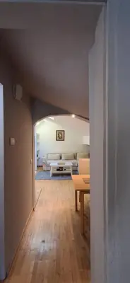 a view of a living room with a table and a couch at IVA Apartman in Belgrade