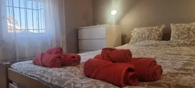 a bedroom with red towels on a bed at IVA Apartman in Belgrade