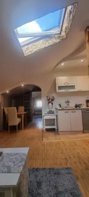 a kitchen with a skylight in the ceiling of a room at IVA Apartman in Belgrade