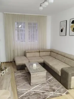 a living room with a couch and a coffee table at Apartman Lazar in Ruma
