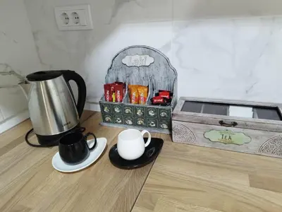 a table with a coffee maker and a tea kettle at Apartman Lazar in Ruma