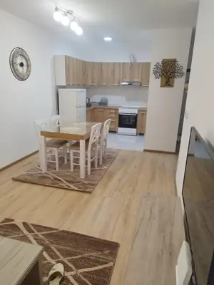 a kitchen and dining room with a table and chairs at Apartman Lazar in Ruma