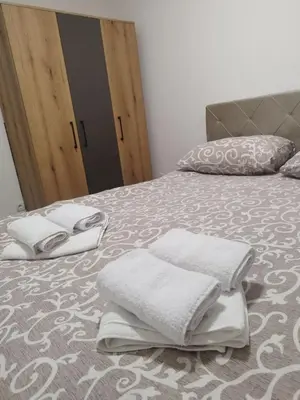 a bed with white towels on top of it at Apartman Lazar in Ruma