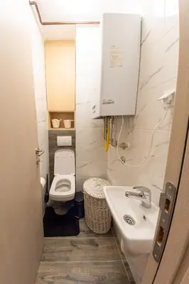a small bathroom with a toilet and a sink at lux Apartman lazar in Pančevo