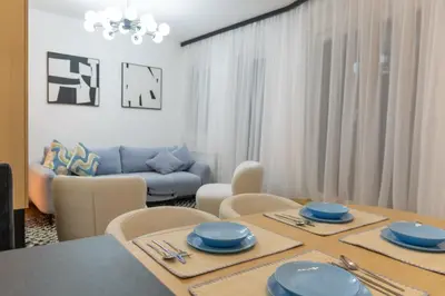 a dining room with a table with blue dishes on it at lux Apartman lazar in Pančevo
