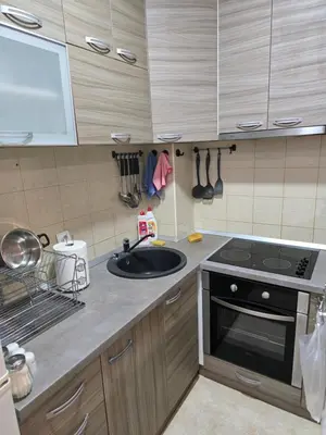 a kitchen with a sink and a stove at Apartman Laki 56 in Kalugjerica