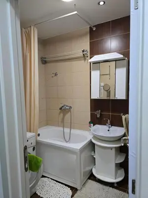 a bathroom with a tub and a toilet and a sink at Apartman Laki 56 in Kalugjerica