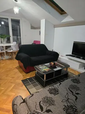 a living room with a couch and a coffee table at Apartman Laki 56 in Kalugjerica
