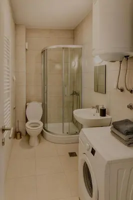 a bathroom with a shower toilet and a sink at Apartman Kalina in Belgrade