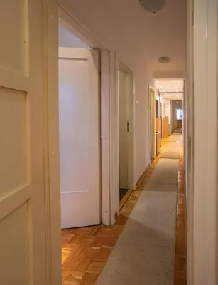 a hallway with a white door and a carpet at Echo Arena in Belgrade