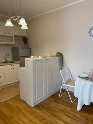 a kitchen with a counter and a table and a chair at Kutak mira in Belgrade